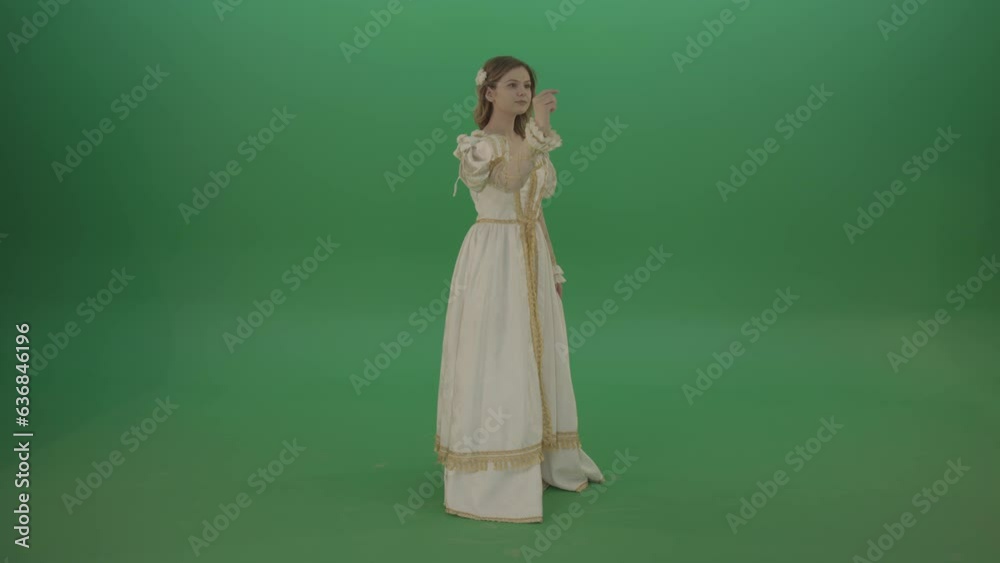 Flips touchscreen in a white suit of a medieval woman isolated on green screen Flips touchscreen in a white suit of a medieval woman isolated on green screen