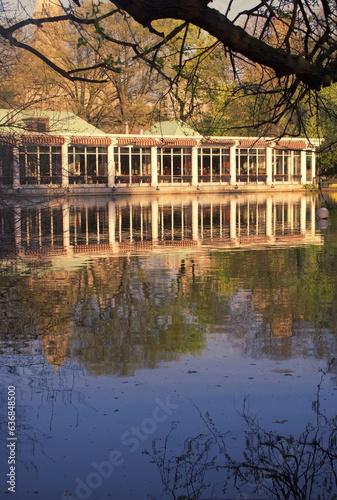 park architecture on a lake lakeside boathouse and reflection in water in a city park 
