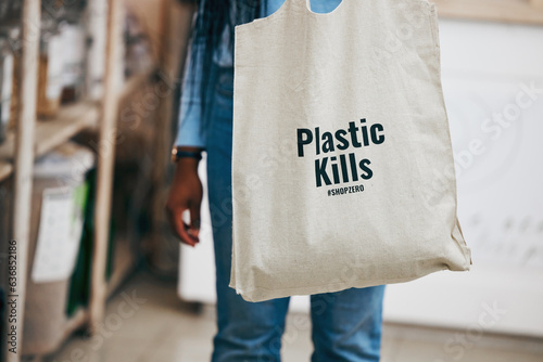 Person in eco friendly grocery store, recycling shopping bag and commitment to climate change at sustainable small business. Zero waste, plastic kills logo and supermarket carbon footprint choice.