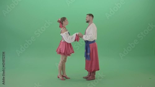 Beautiful Ukrainian couple speaking about love in ethno costumes isolated on green screen - 4K Video Footage (ID: 636852306)