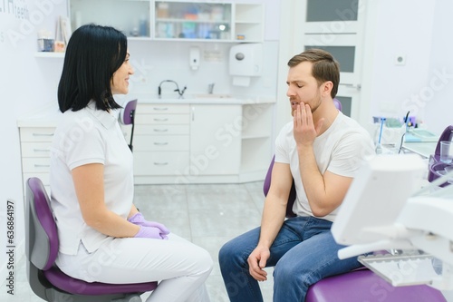 female dentist with male patient at clinic