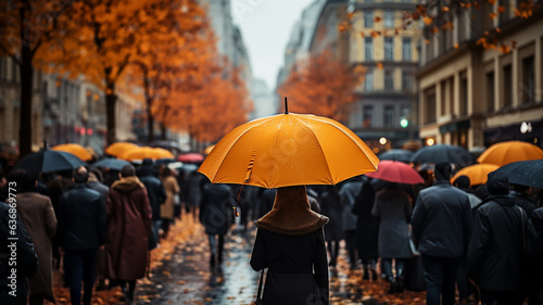 the flow of people with umbrellas on a pedestrian street autumn weather in the city