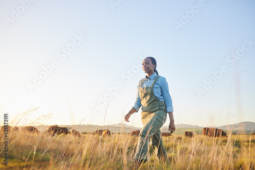 Woman, farmer and walking in countryside on grass field with cow and cattle worker. African female person, and agriculture outdoor with animals and livestock for farming in nature with mockup space