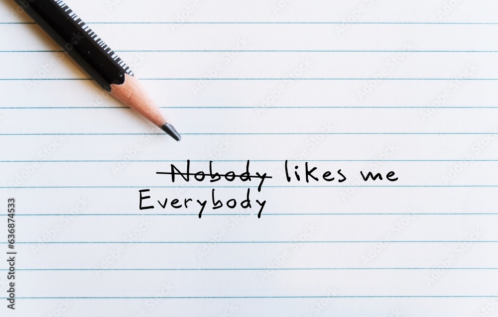Pencil on paper with text written NOBODY LIKES ME changed to EVERYBODY LIKES ME to replace negative thoughts which distort perception of oneself, overcome with positive thinking and self-acceptance Pencil on paper with text written NOBODY LIKES ME changed to EVERYBODY LIKES ME to replace negative thoughts which distort perception of oneself, overcome with positive thinking and self-acceptance