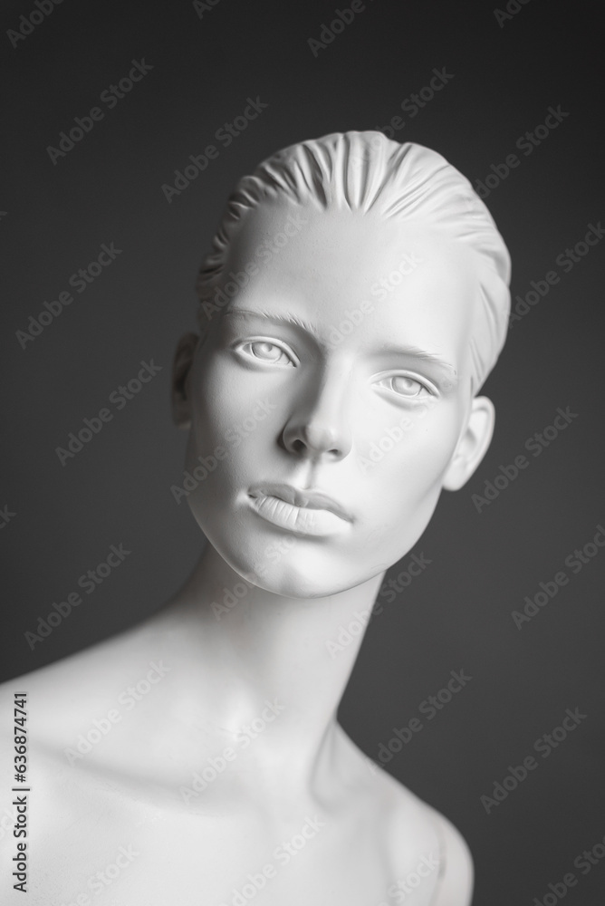 Portrait of luxury white female mannequin isolated on gray background.