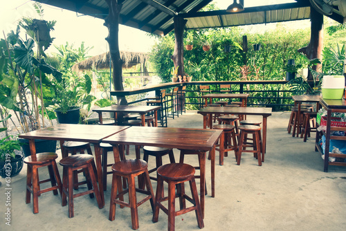 The wooden tables in front of the coffee shop and iron tables have soft cushions.