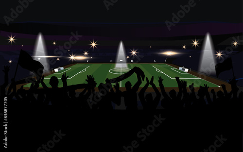 Spectators cheering for sports in the stadium in silhouettes A soccer pitch is illuminated at night with flashing lights, fans standing in the shadows, and spectators waving flags from the seats.