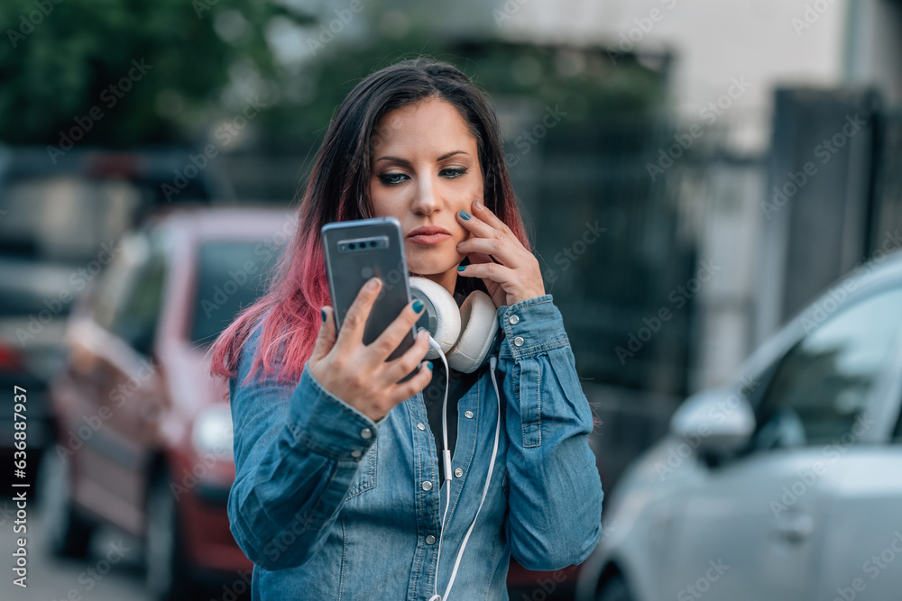 urban young woman with headphones and mobile phone in the street