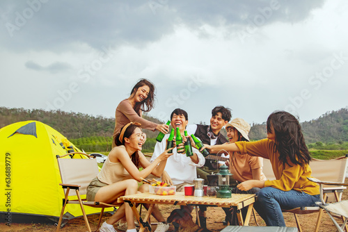 Meeting for fun vacation trips camping trips natural places : Happy group male and female friends singing songs and drinking beer having fun on vacation travel camping holiday trips natural fields.