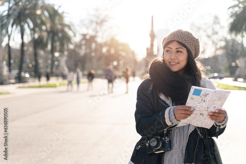 Photography Young asian traveler holding city map in winter vacations - Tourist woman in Eur