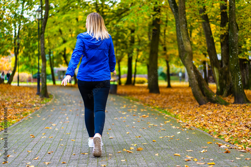 Healthy lifestyle - woman walking in city park
Healthy lifestyle - woman walking in city park