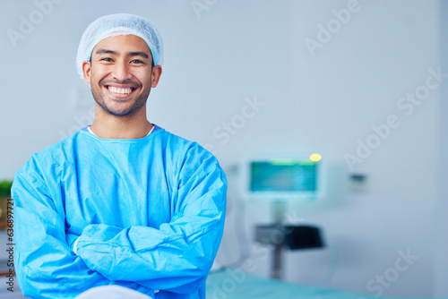 Portrait, surgeon and Asian man with arms crossed in hospital, healthcare and wellness. Face, happy doctor and medical professional, expert nurse and confident surgery employee in scrubs in Cambodia photo