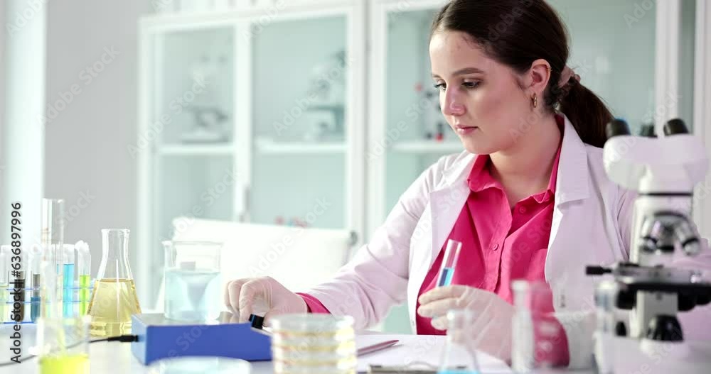 Laboratory practitioner works with samples and liquid in premise. Specialist in robe prepares for lab examination of liquids slow motion Laboratory practitioner works with samples and liquid in premise. Specialist in robe prepares for lab examination of liquids slow motion