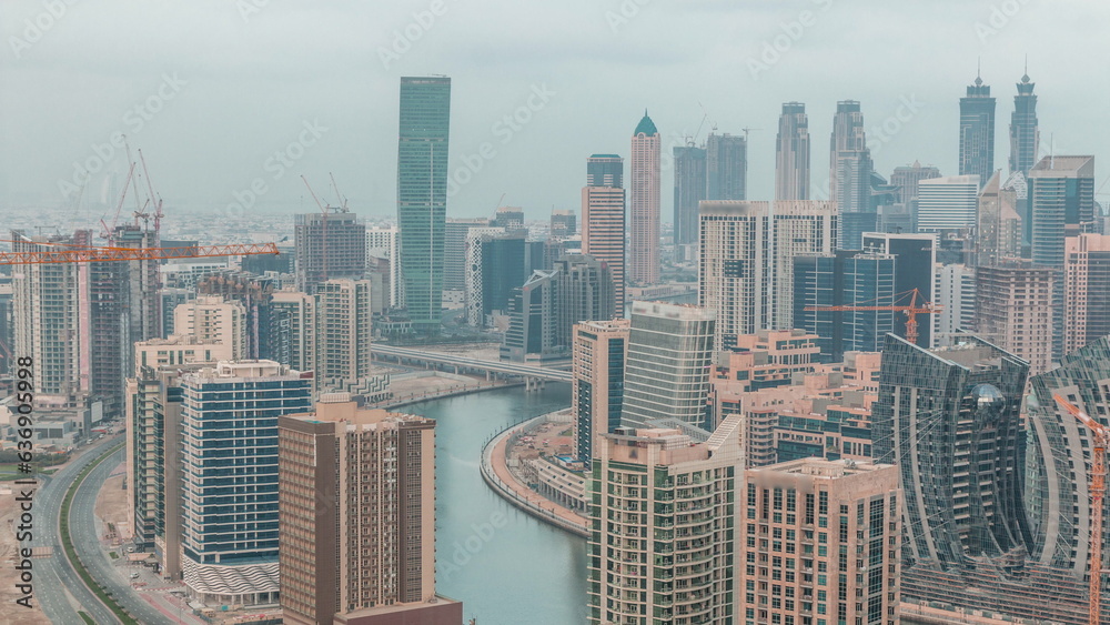 Skyline with modern architecture of Dubai business bay towers night to day timelapse. Aerial view Skyline with modern architecture of Dubai business bay towers night to day timelapse. Aerial view