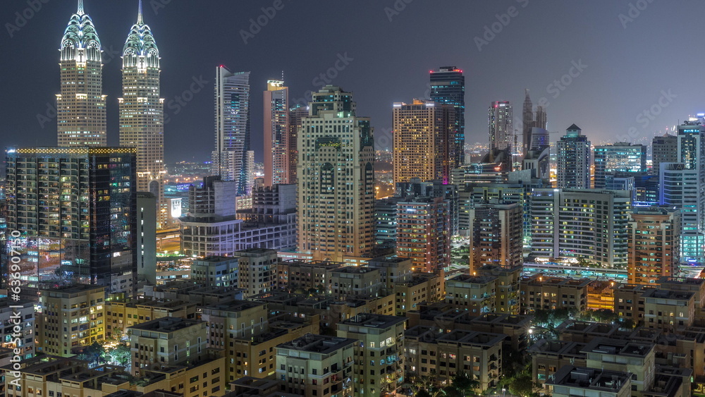 Skyscrapers in Barsha Heights district and low rise buildings in Greens district aerial day to night timelapse.
