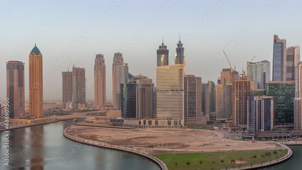 Obraz premium Cityscape of skyscrapers in Dubai Business Bay with water canal aerial night to day timelapse