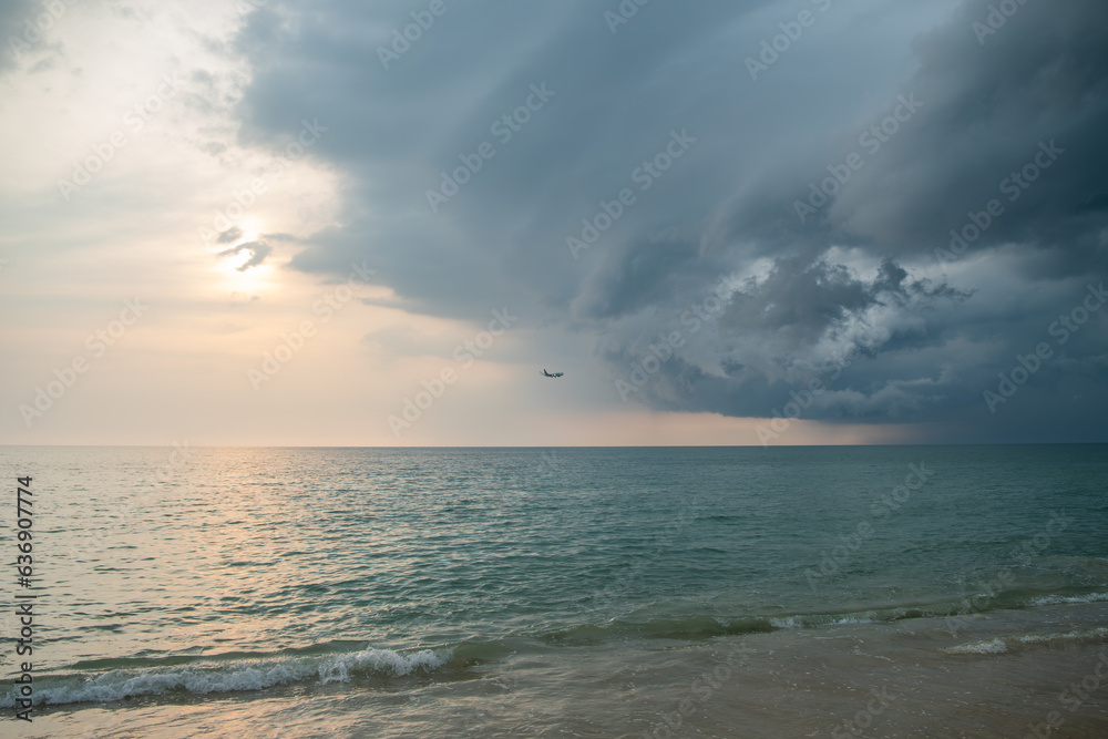 air planes and rain clouds in the sky at seacoast in evening