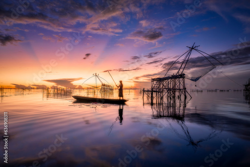 Fisherman go fishing in the morning during sunrise time at Pak Pra, Phatthalung in Thailand.  © Jack