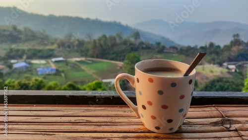 Hot coffee in cup and blurred nature background.
