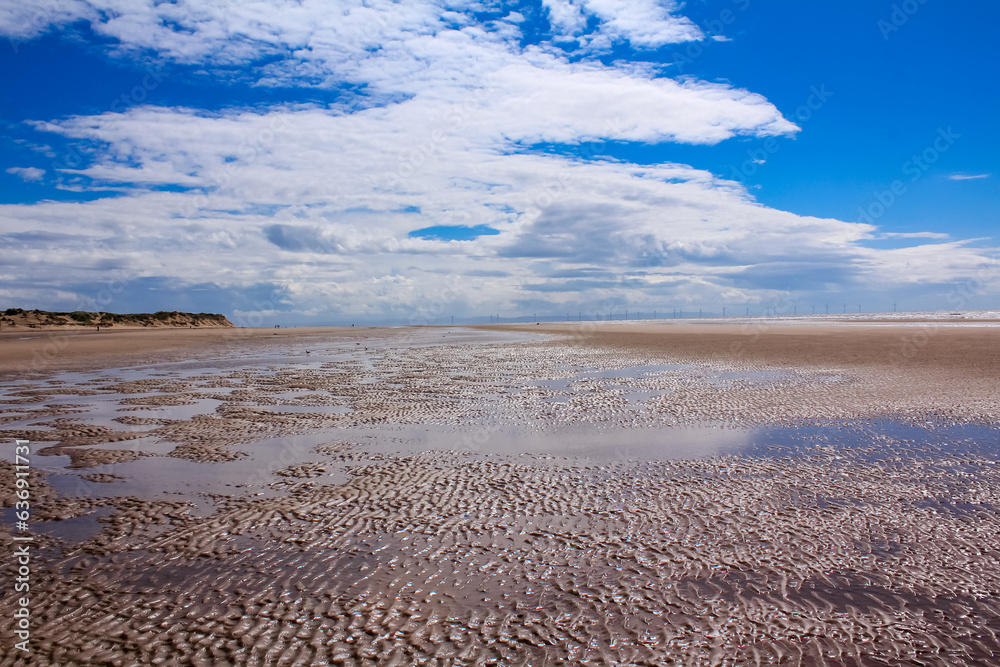 The view of the Formby Beach (Victoria Road Beach) or Formby Dunes in Liverpool, UK at sunny day. City in Merseyside county of North West England. Including the famous sand dunes. Nature, travel scene The view of the Formby Beach (Victoria Road Beach) or Formby Dunes in Liverpool, UK at sunny day. City in Merseyside county of North West England. Including the famous sand dunes. Nature, travel scene