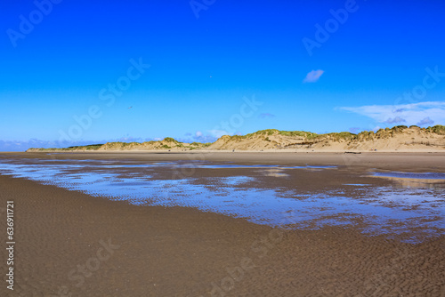 The view of the Formby Beach  Victoria Road Beach  or Formby Dunes in Liverpool  UK at sunny day. City in Merseyside county of North West England. Including the famous sand dunes. Nature  travel scene