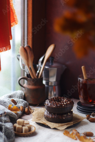 Chocolate donuts in an autumn style still life