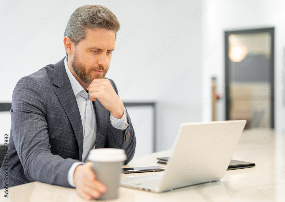Businessman with laptop at office. Businessman in suit in office work on laptop computer. Office business man using laptop. Businessman work on laptop. Businessman have online work in office interior. Businessman with laptop at office. Businessman in suit in office work on laptop computer. Office business man using laptop. Businessman work on laptop. Businessman have online work in office interior.