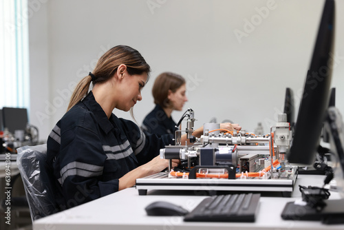 Wallpaper Mural engineer using a camera to take photos of  a motherboard prototype  robot in the training class Torontodigital.ca