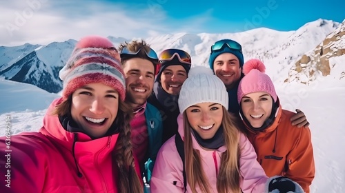 Group of friends taking selfie with mobile phone on snowy mountain in winter 