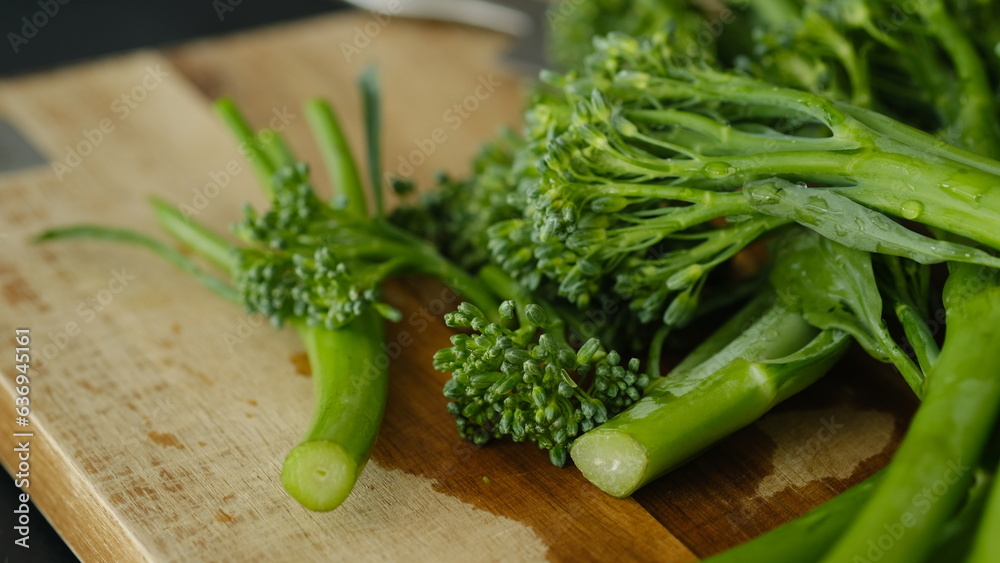 Fresh Broccolini vegetables on a cutting board. Fresh Broccolini vegetables on a cutting board.