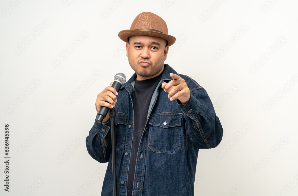 Happiness young asian man singing song. Artist vocalist singer on isolated background. Confident man public speaking talking with microphone in studio. Happiness young asian man singing song. Artist vocalist singer on isolated background. Confident man public speaking talking with microphone in studio.