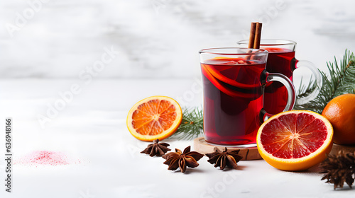 Christmas mulled red wine with spices and fruits on a white background. Traditional hot drink at Christmas time
