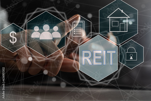 REIT, Real Estate Investment Trust concept, Person hand using smart phone with Real Estate Investment Trust icon on virtual screen. photo