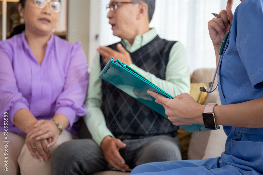 Caregiver sitting on sofa checkup and diagnostic with elderly couple patient about health in living room at home, caretaker sitting on couch explaining and examining senior, insurance and medical.