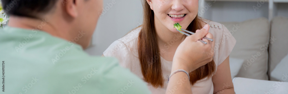 Happiness asian family with husband and wife eating dining food together in the kitchen at home, happy couple eating lunch with enjoy, dating and honeymoon, lifestyles and nutrition concept.
