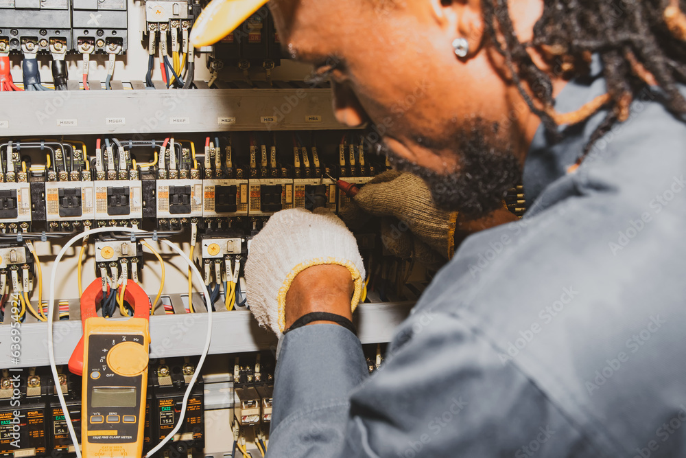 African male electrician engineer working inspect electrical system
