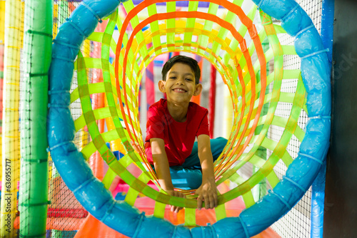 Cheerful kid having fun looking excited during recreation time photo