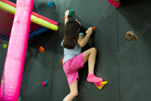 Beautiful child enjoying her recreation time rock climbing
