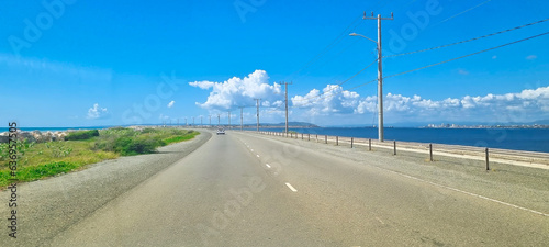 Road on Palisadoes a thin strip of sand that serves as a natural protection for Kingston Harbour, Jamaica