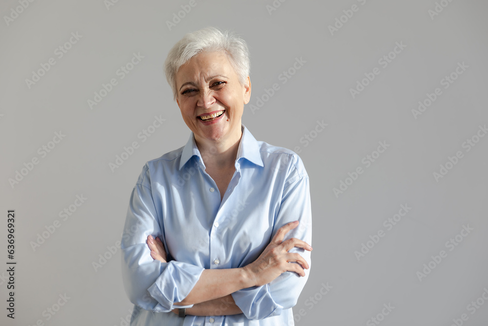 Confident stylish european middle aged senior woman. Older mature 60s lady smiling in white background. Happy attractive senior female looking camera close up face headshot portrait. Happy people