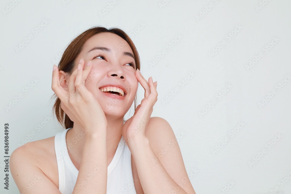 Beautiful Asian woman in natural makeup over isolated background with copy space. Beautiful Asian woman in natural makeup over isolated background with copy space.