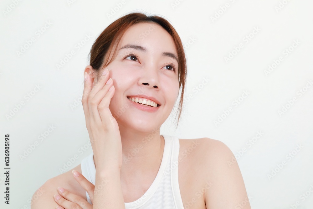 Beautiful Asian woman in natural makeup over isolated background with copy space. Beautiful Asian woman in natural makeup over isolated background with copy space.