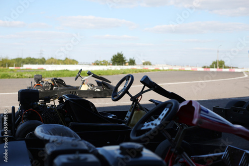 Racing cars for karting stand near the track before the start of the competition