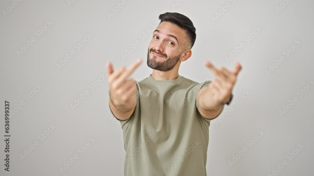 Young hispanic man smiling confident doing middle finger gesture over isolated white background
