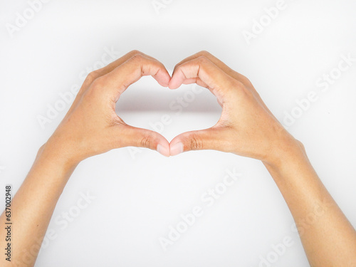 Female hands making sign Heart by fingers  isolated on white background. Beautiful hands of woman with copy space.
