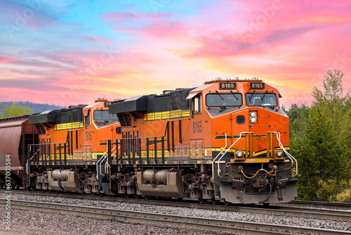 freight train close to Whitefish, Montana with colorful sky in background