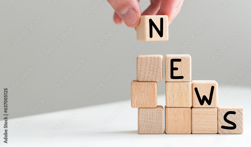 Wooden news sign on a table in an office Wooden news sign on a table in an office