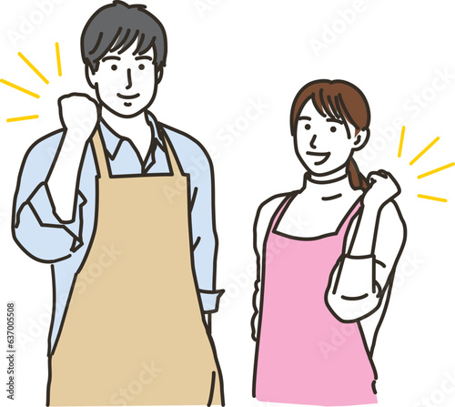 ガッツポーズをするエプロン姿の男女
