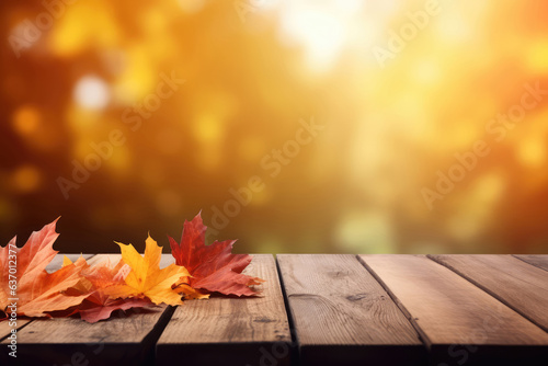 Wooden table with autumn leaves on bokeh background. Autumn concept