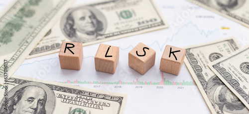 Word risk. Business concept on wooden cubes and dollars background